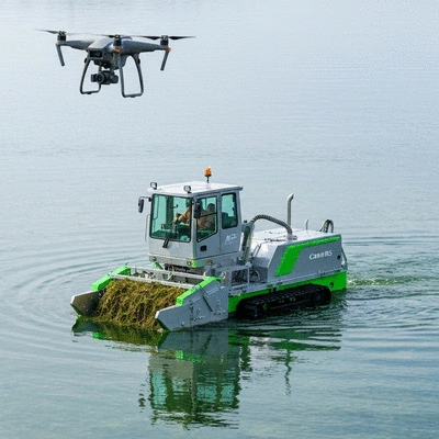 AI-driven autonomous aquatic weed harvester in action on a clear lake